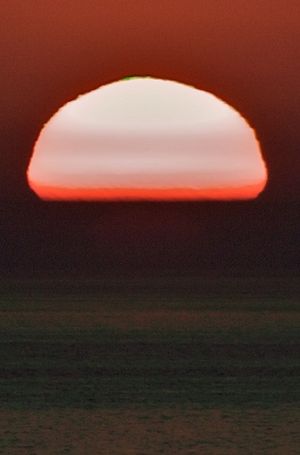 solnegang med grønt glimt